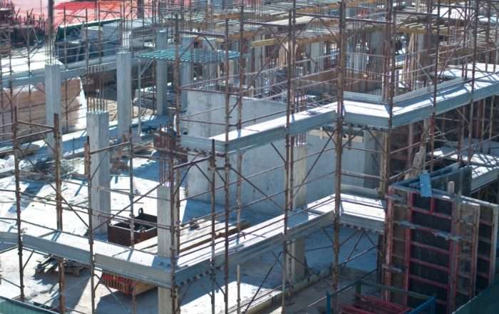 A transfer slab is simply a thick reinforced concrete floor slab where a column sits on top of a slab but does not have a column immediately below. In other words, it bridges between supporting columns and provides support to columns from the upper parts of a building.